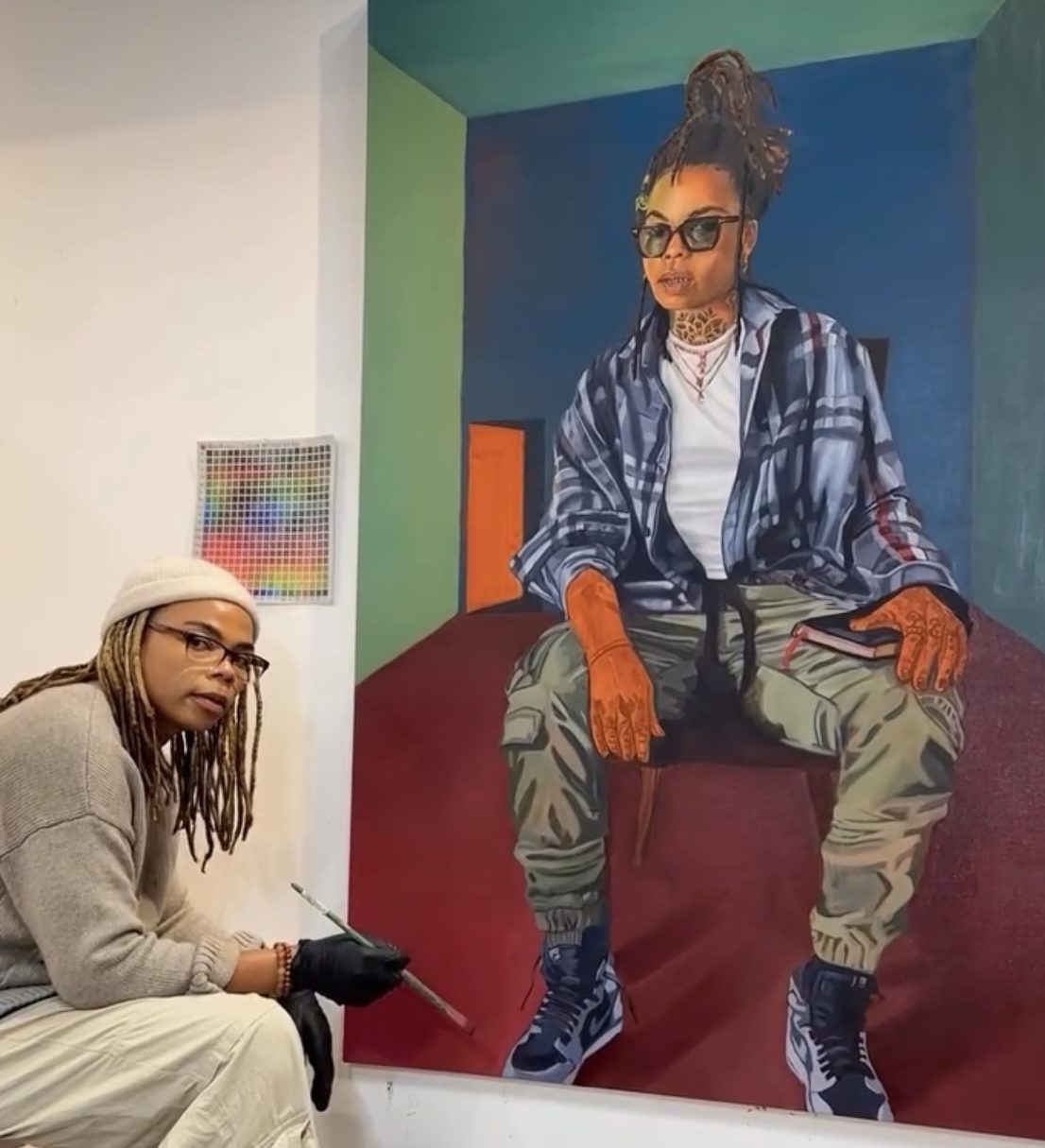 Artist exhibiting their artwork in a gallery